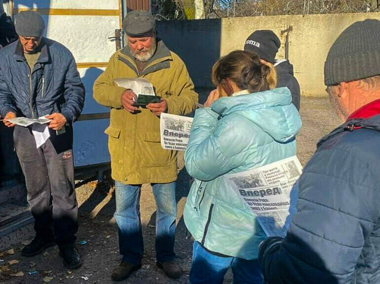 Bewohner:innen in Bachmut lesen eine Ausgabe der Wochenzeitung "Vpered". (Foto: Vpered)